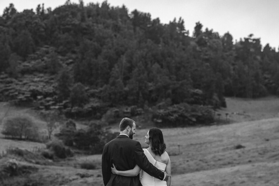 Bride and Groom looking at the country views after their wedding at the run Whakatane