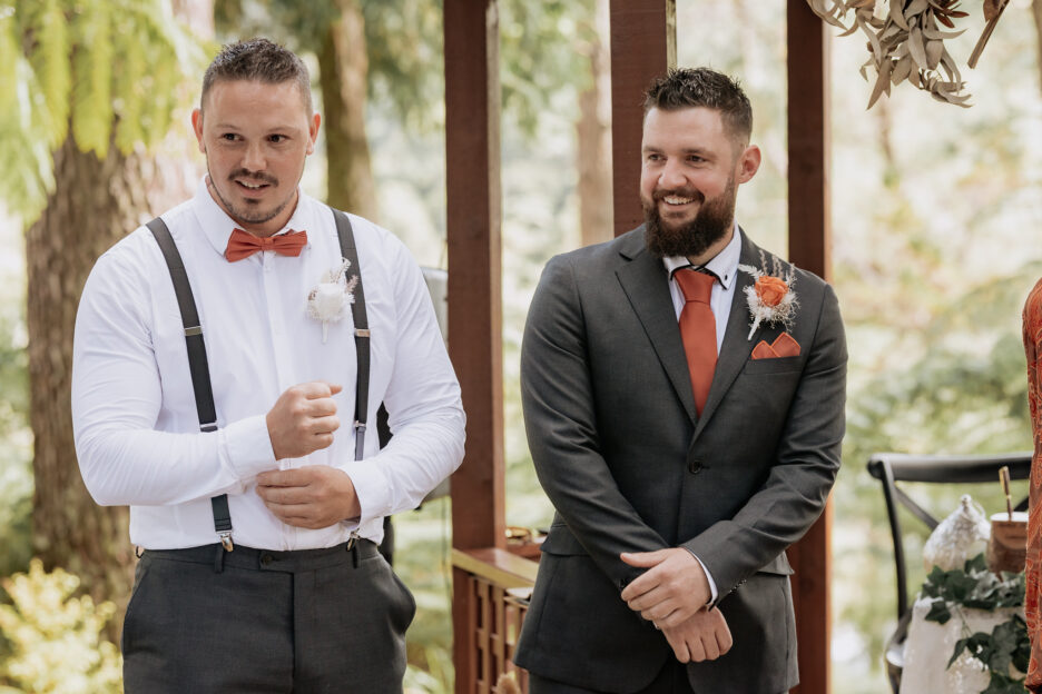 Groom and groomsmen smiling awaiting brides arrival