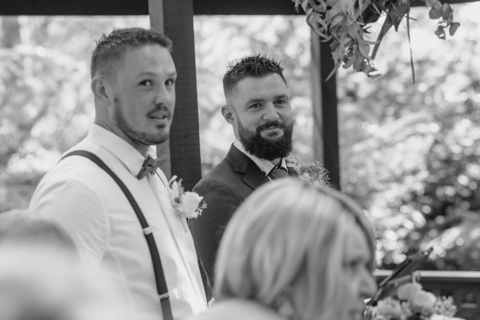 groom watches bride walk down aisle