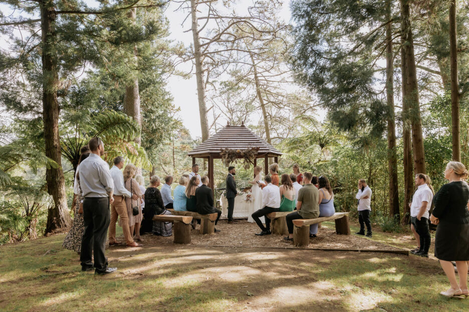 Getting married in the garden in front of waterfall at Falls Retreat