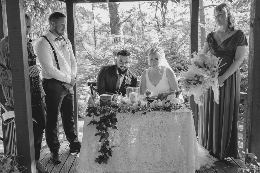 Wedding party signing at table