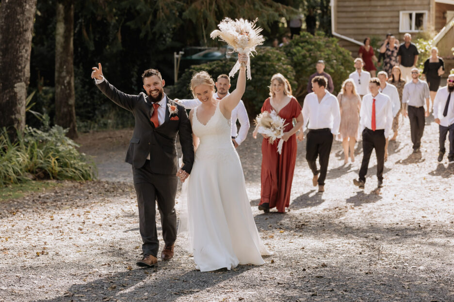 Hands in air celebrating just married with guests