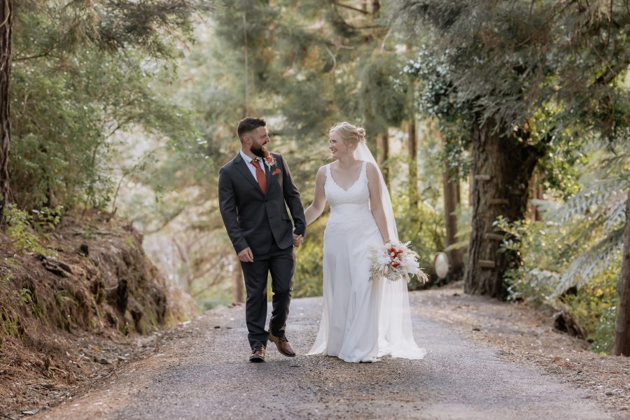 Wedding couple walking up driveway at Falls Retreat