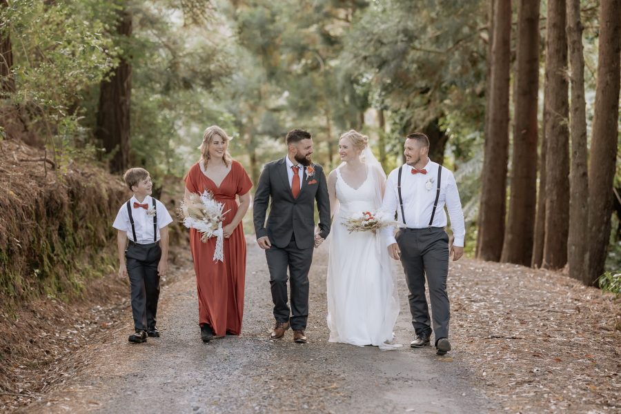 Wedding party walking driveway at Falls Retreat Waihi Karangahake Gorge