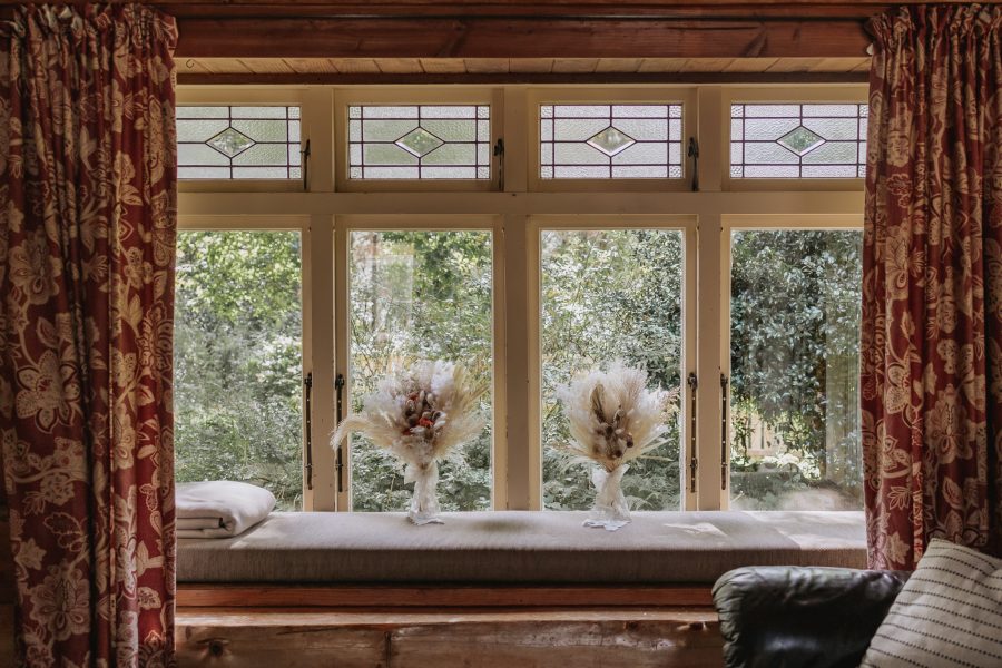 dried floral bouquets in window of country cottage