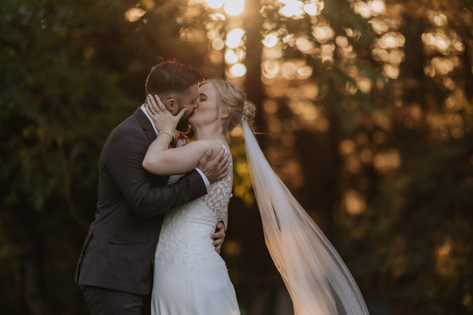 Bridal couple kissing in golden light