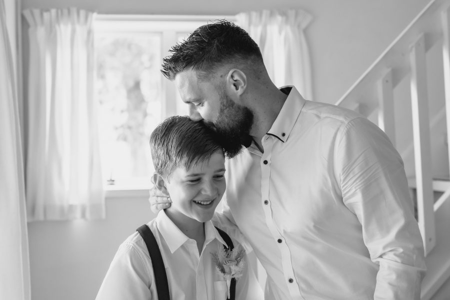 groom kisses sons head