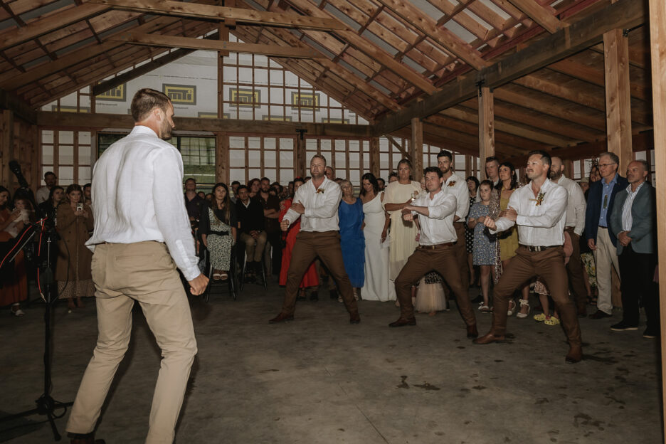 Groom and Groom performing New Zealand Maori Haka