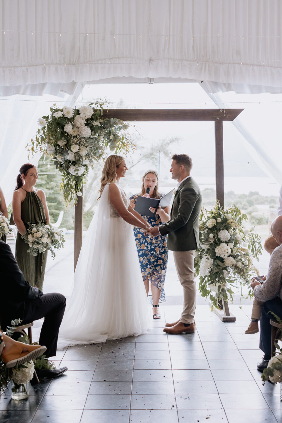 Bride and Groom holding hands during wedding ceremony in Rotorua