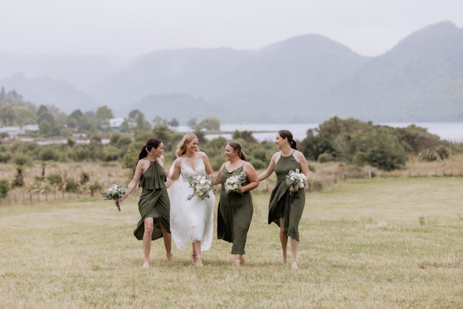 Bridal squad in olive green walking in the country in Lakes Rotorua New Zealand