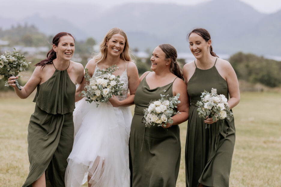 Happy bride and bridemaids in Olive green laughing having fun at Longfords Estate