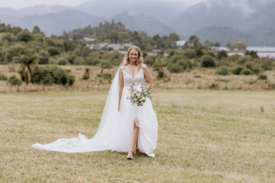 Bride walking in Madison Rose bridal dress at Longfords Estate Rotorua