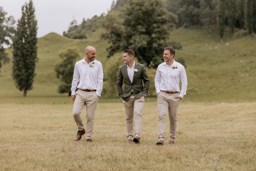 Groomsmen in country attire walking lake Okareka Rotorua New Zealand