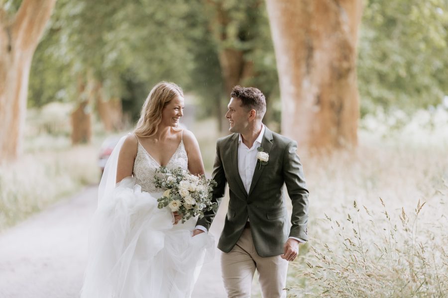 Natural wedding photo in driveway with high grass Rotorua lakes wedding