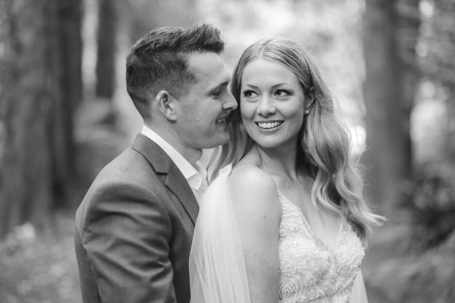 Groom whispers into ear of happy bride