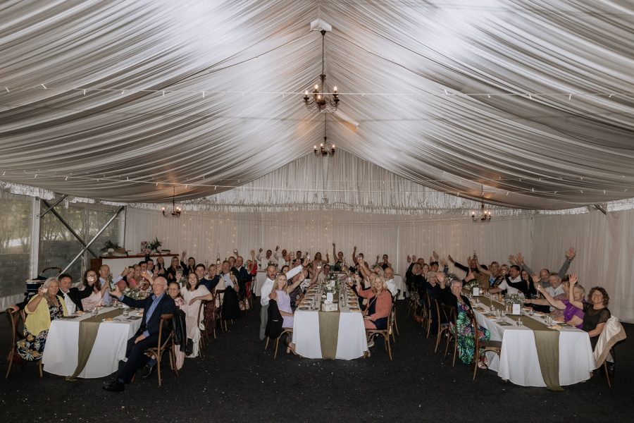 Longfords estate guests waving at camera seated at reception