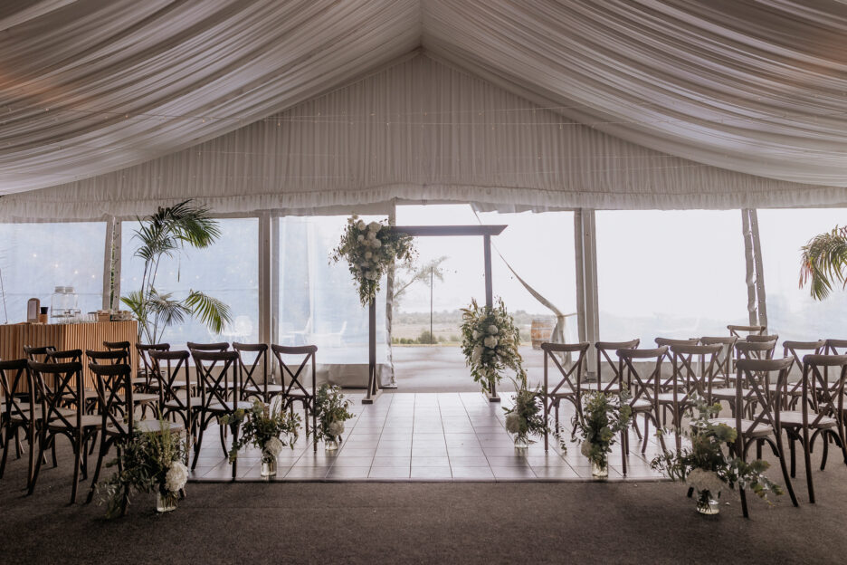 Indoor wedding ceremony area at Longfords estate with Lake Okareka in distance
