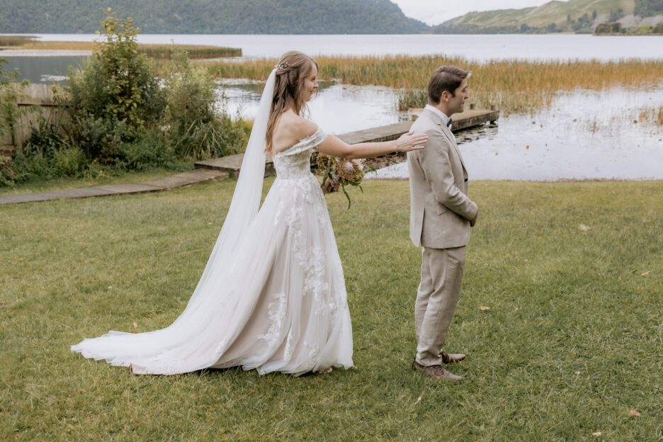 first look photo before ceremony of bride and groom by Lake Okareka