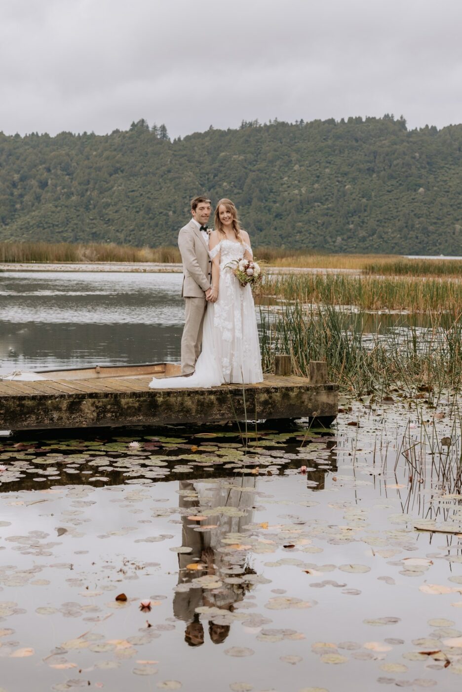 Wedding photos taken on wharf at Lake Okareka at longfords estate