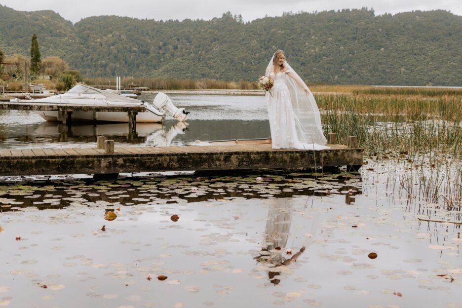 Bride on wharf holding he veil