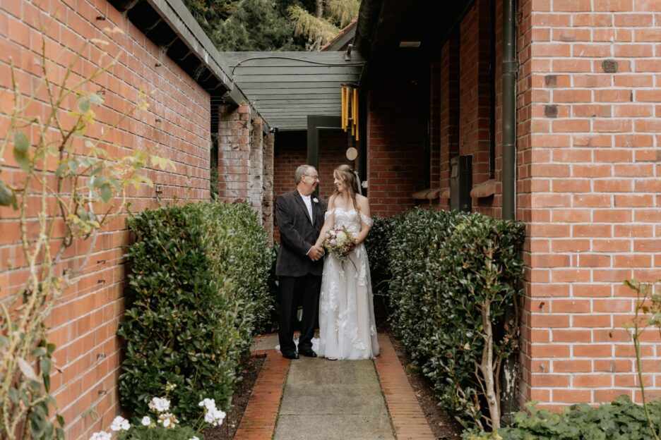 Bride waits with her father before walking aisle