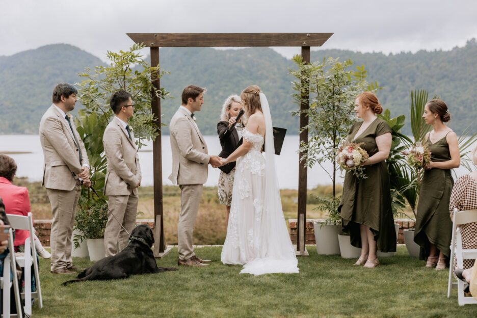 Wedding ceremony in progress overlooking lake at longfords estate