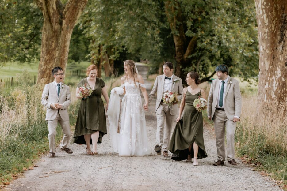 Wedding party walking longfords estate driveway during photos with Pure Images Photography