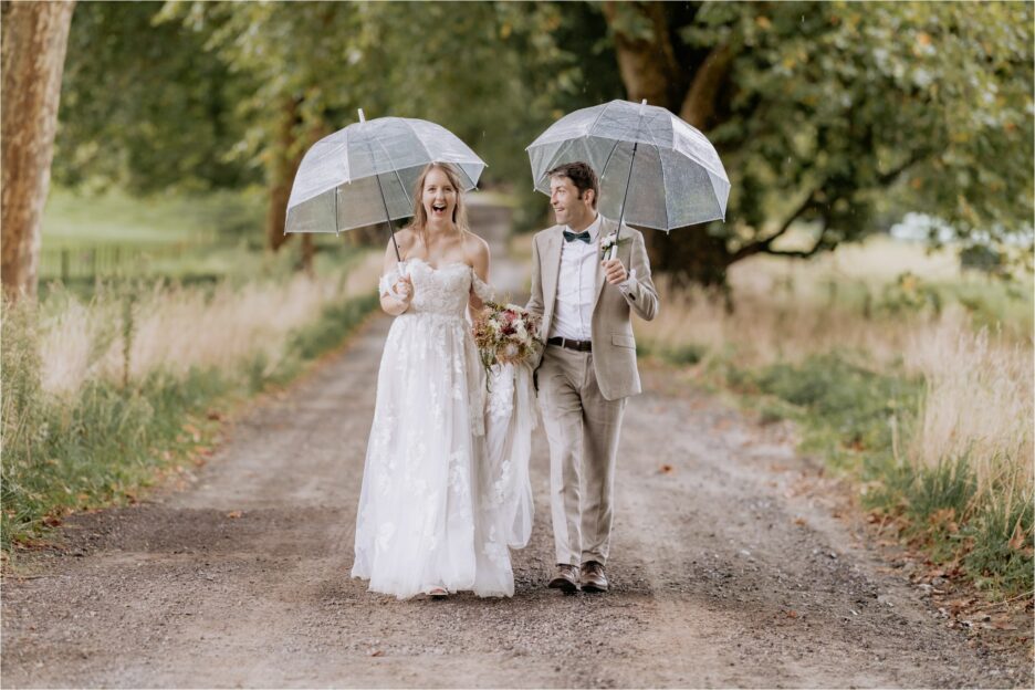 Wedding couple laughing during photos on driveway Longfords Estate