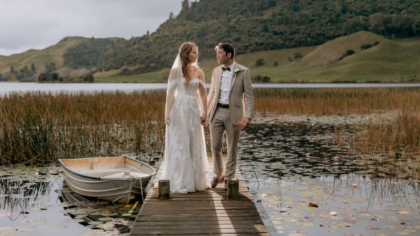 Wedding couple walking while in rains at Lake Okareka photos taken by Pure Images Photography