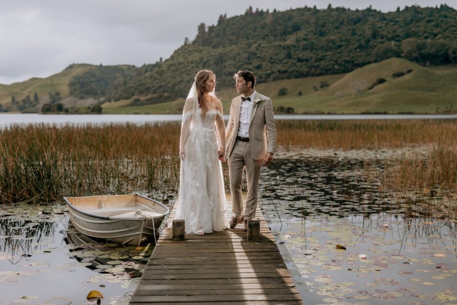 Wedding couple walking while in rains at Lake Okareka photos taken by Pure Images Photography