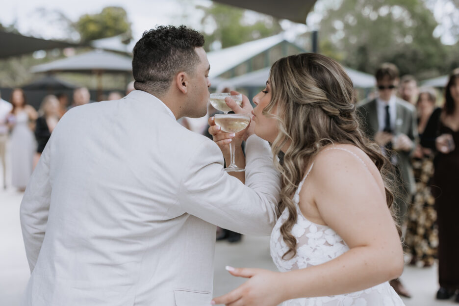 bride and groom drinking champagne