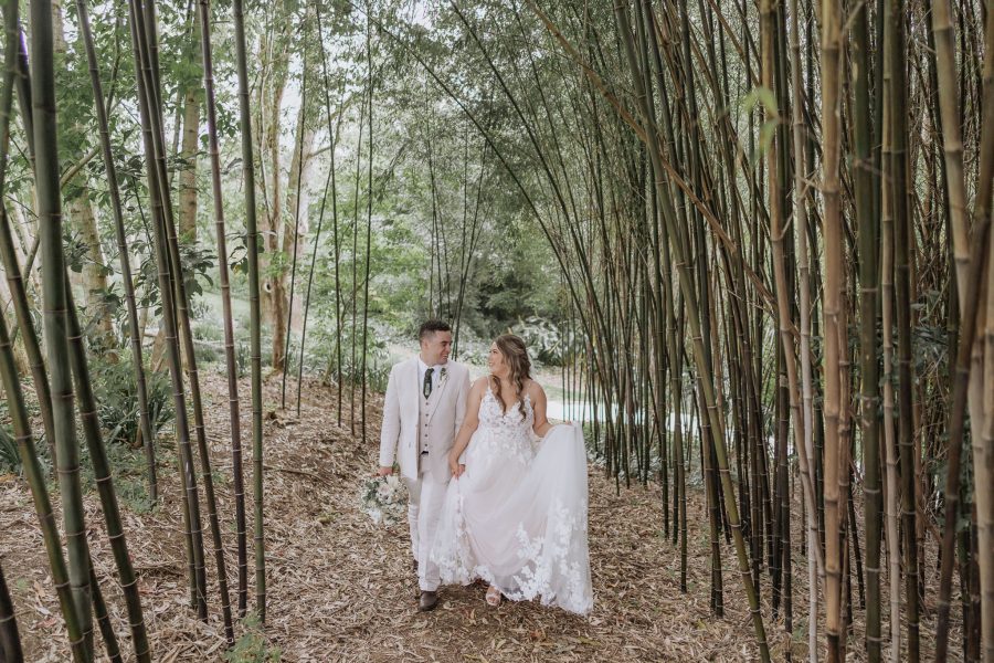 bride and groom looking at each other between the bamboos at black walnut wedding venue