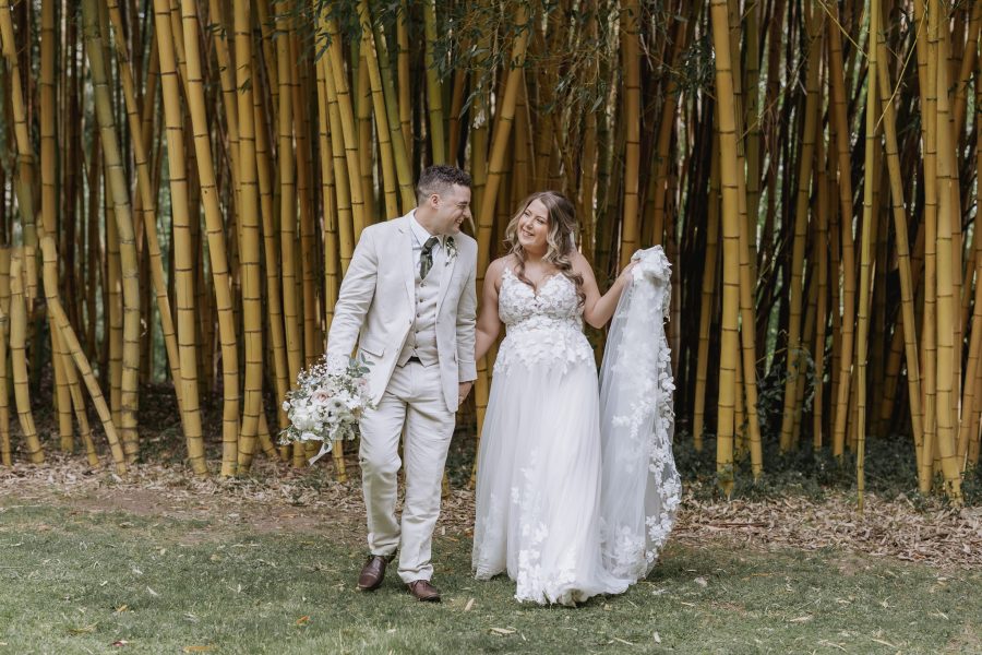 bride and groom walking at black walnut in the bamboo trees