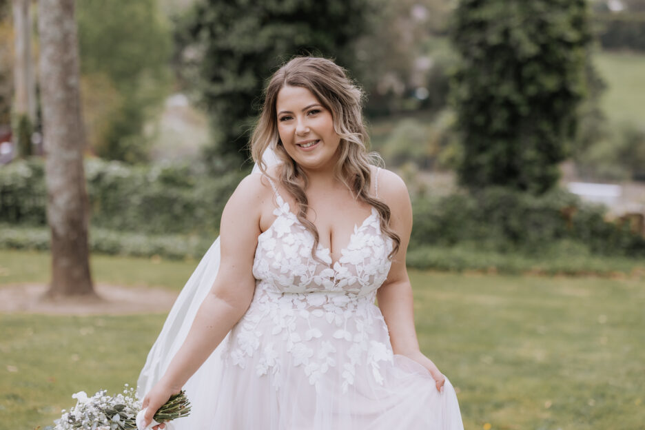 bride walking holding dress at black walnut