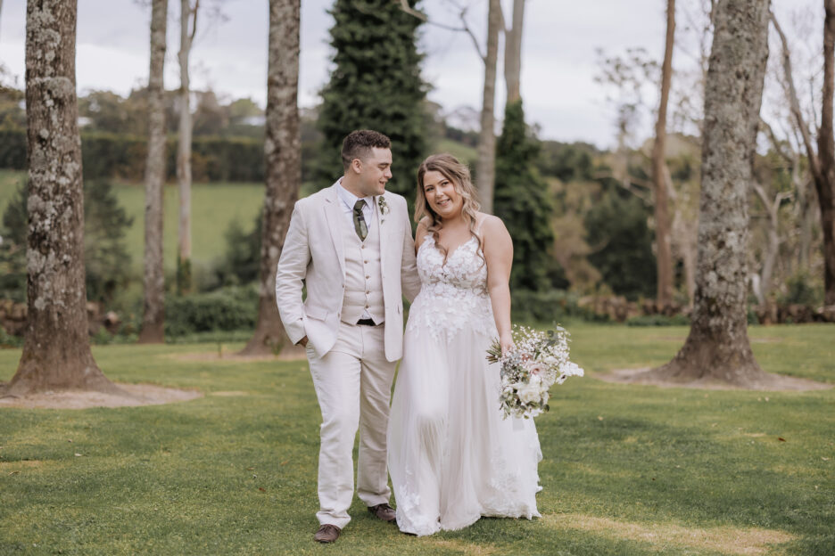 bride and groom walking in the garden at black walnut wedding venue