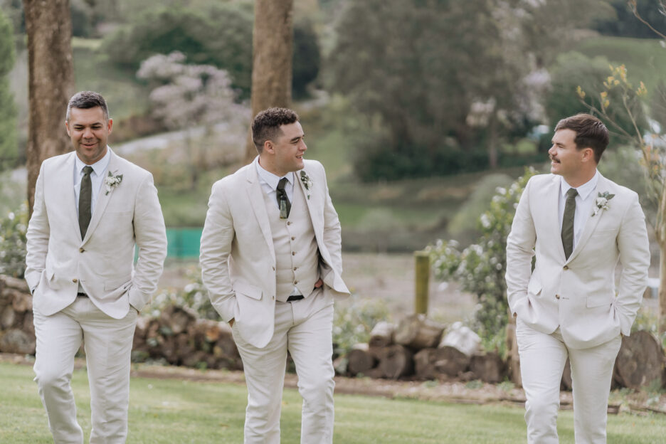 groom walking with his groomsmen in linen at black walnut