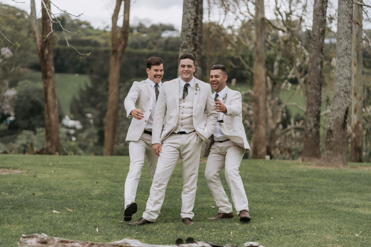 groomsmen rush groom