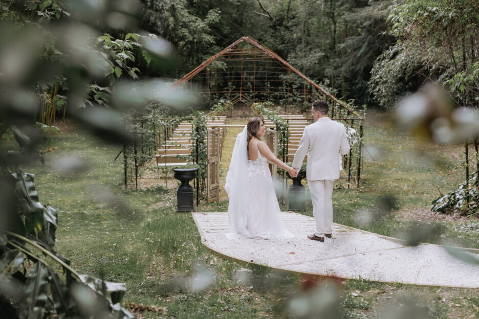 bride and groom walking to tree church at black walnut