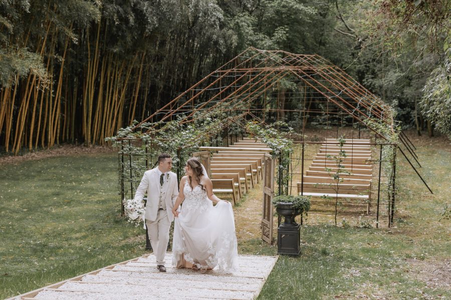 bride and groom walking up steps tree church at black walnut wedding venue
