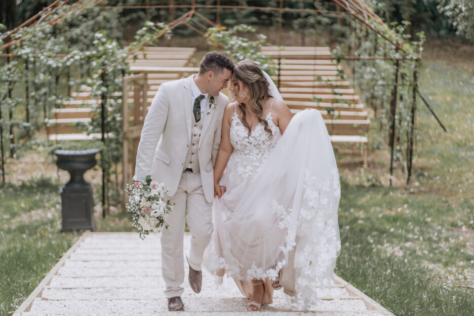 wedding couple walk up steps in front tree church at black walnut tauranga