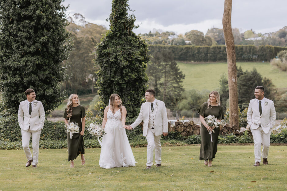 wedding party walking at black walnut under the trees