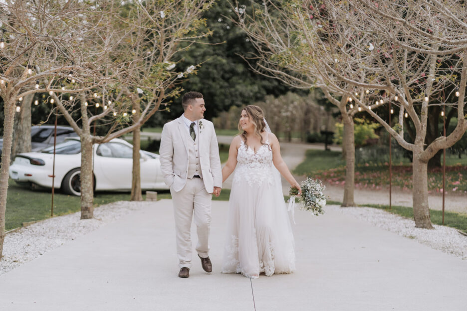 walking up the driveway at black walnut between blush pink trees in springtime