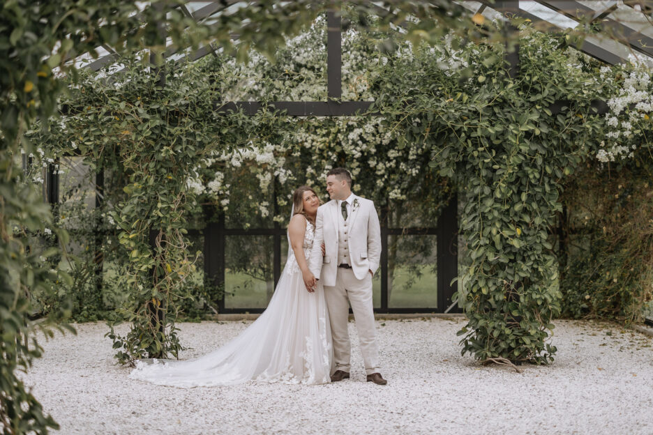 wedding photos taken inside the glass house at black walnut wedding venue in tauranga