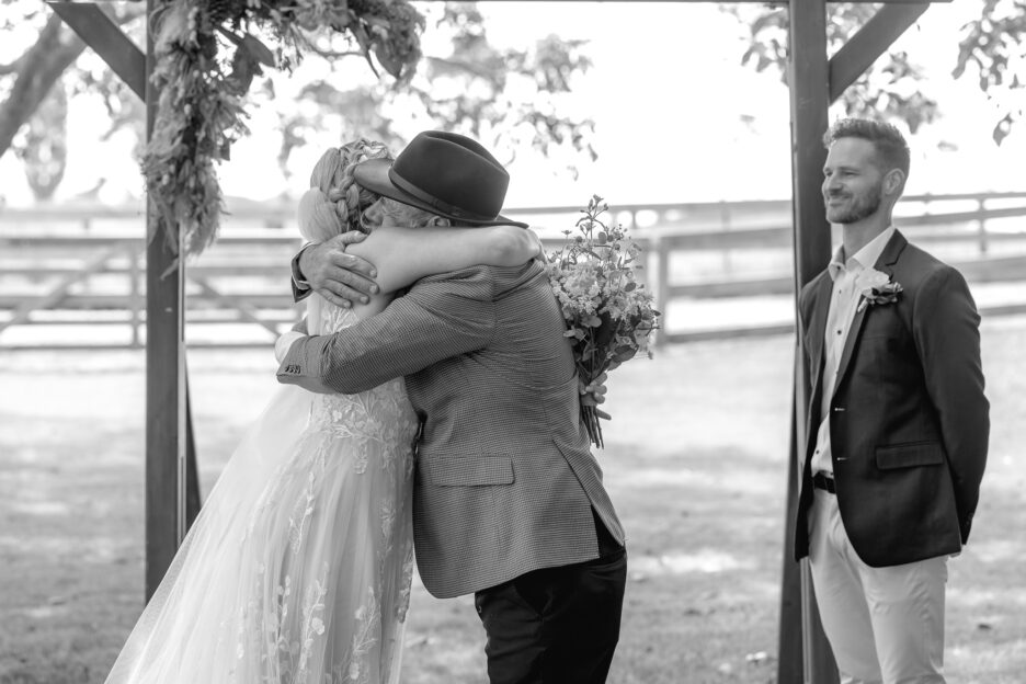 Father hugs bride