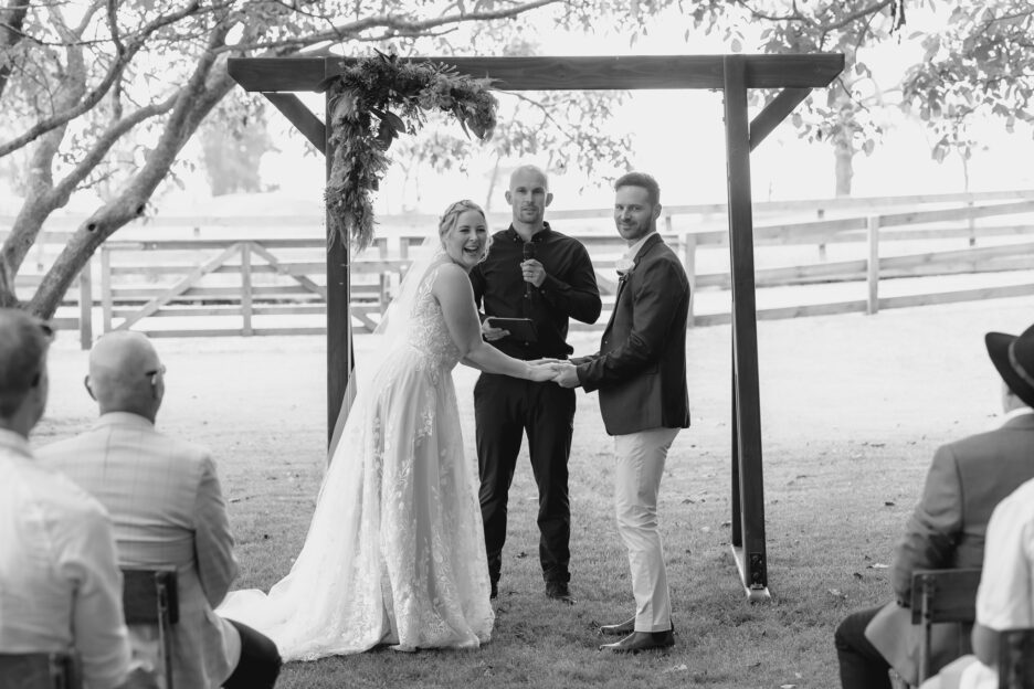 bride and groom laugh at guests