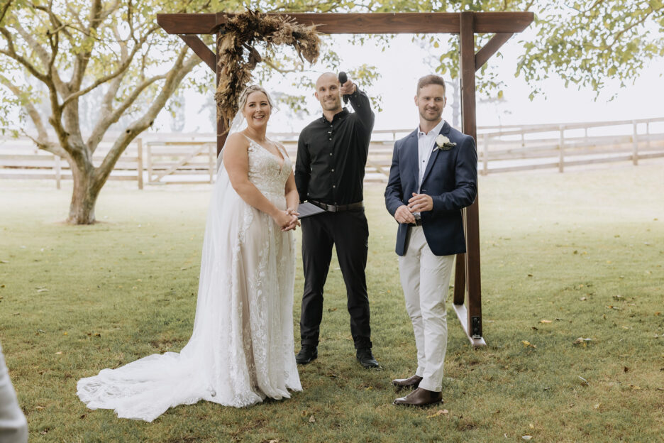 groom and bride look to guests