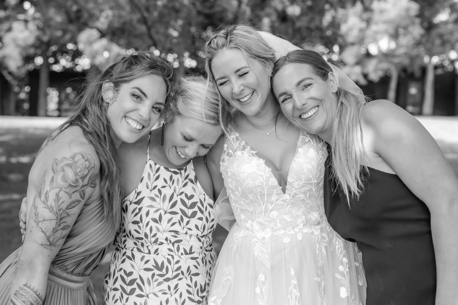 Bride hugs bridesmaids Te Tumu estate