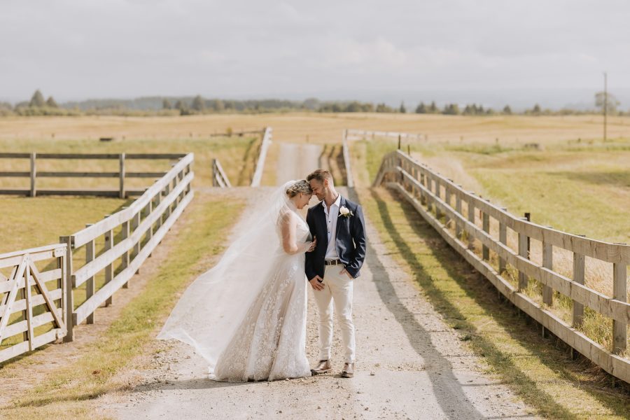 moment between bride and groom Te Tumu estate driveway