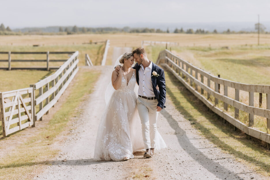 Wedding couple walking down road at Te Tumu Estate