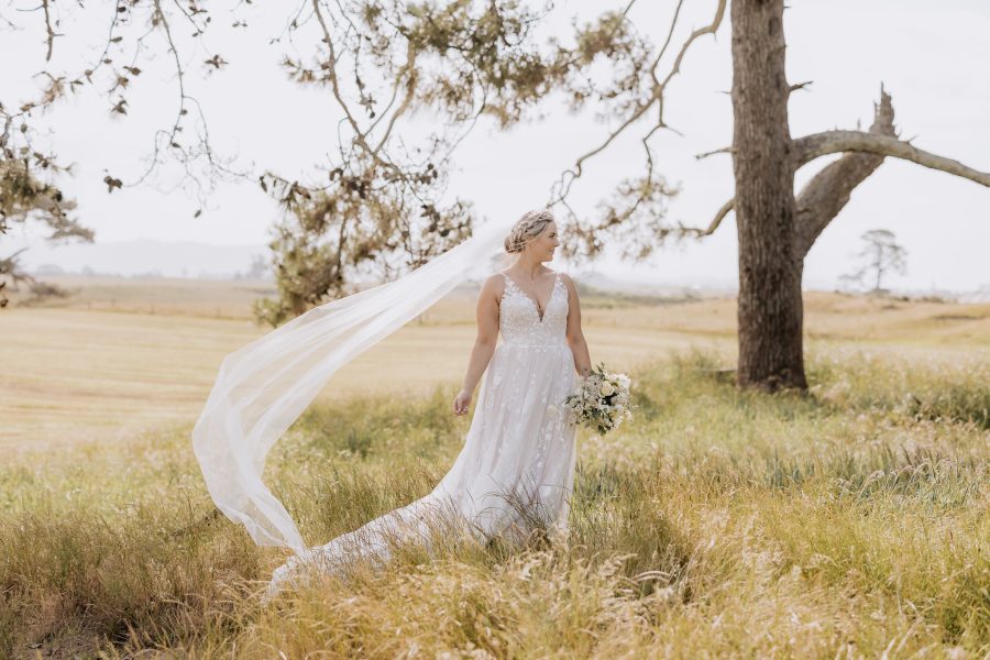Bride with madisonrose bridal gown in high grass